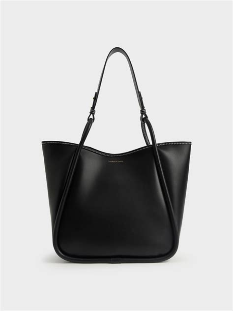 M. £89.00 £59.00. 34% OFF. Add to bag. Altea Plaid Bucket Bag - black textured. £89.00 £59.00. 34% OFF. Browse CHARLES & KEITH’s online bags sale to find your perfect everyday companion. Find clutches, crossbody bags, totes, wallets and more.. Charles and keith tote bag
